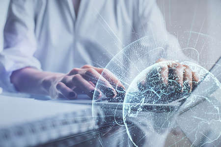 Double exposure of woman hands typing on computer and social network theme hologram drawing. People...
