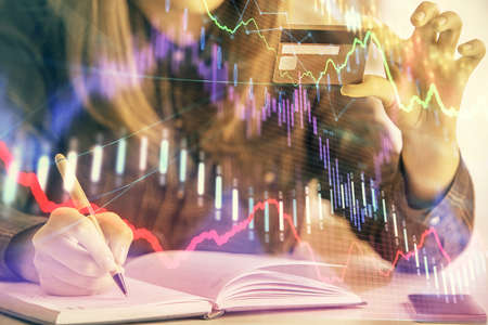 Multi exposure of woman on-line shopping holding a credit card and financial graph drawing. Stock...