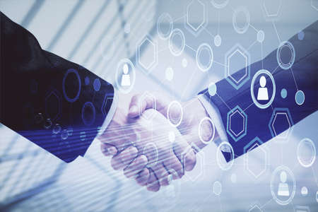 Double exposure of social network theme hologram and handshake of two men.
