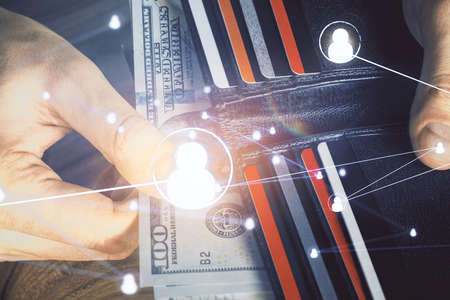 Multi exposure of social network theme drawing hologram and USA dollars bills and man hands.の写真素材