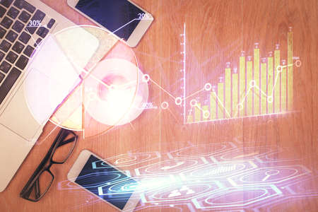 Multi exposure of financial chart hologram over desktop with phone. Top view. Mobile trade platform...