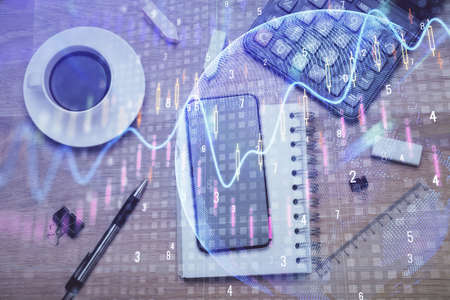 Multi exposure of forex graph hologram over desktop with phone. Top view. Mobile trade platform...