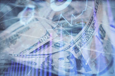 Double exposure of forex graph drawing over us dollars bill background. Concept of financial markets.の写真素材