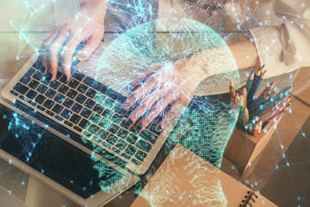 Double exposure of woman hands working on computer and brain hologram drawing. Ai concept.