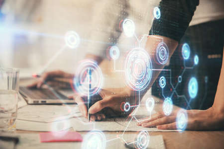 Double exposure of woman hands working on computer and data theme hologram drawing. Tech concept.