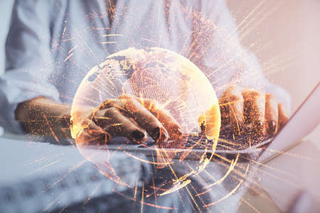 Double exposure of woman hands typing on computer and social network theme hologram drawing. People...