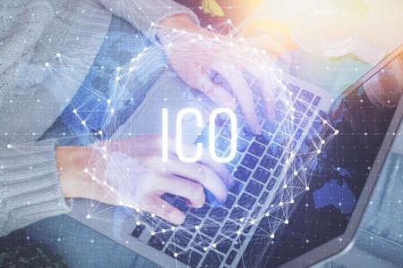 Double exposure of woman hands typing on computer and crypto market theme hologram drawing. Blockchain concept.の写真素材