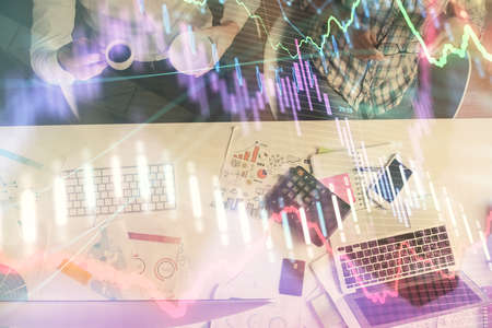 Double exposure of man and woman working together and financial chart hologram drawing. market...