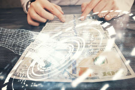 Double exposure of technology drawing hologram and us dollars bills and man hands. Data concept
