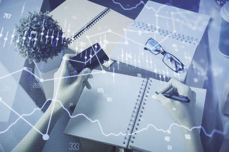 Multi exposure of woman on-line shopping holding a credit card and financial graph drawing. Stock...