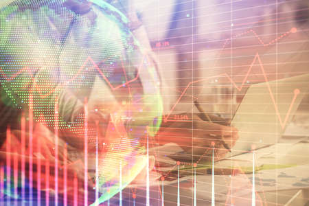 Multi exposure of man and woman working together and financial chart hologram. Business concept....