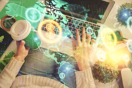 Double exposure of woman hands working on computer and forex chart hologram drawing. Top View....