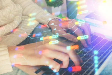 Double exposure of woman hands working on computer and data theme hologram drawing. Tech concept.
