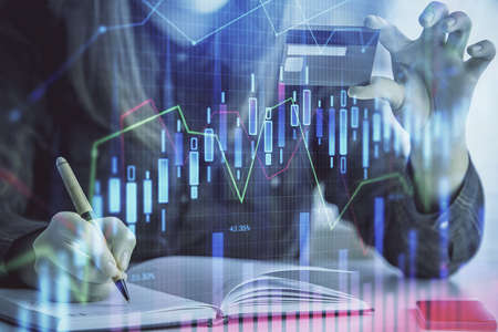 Multi exposure of woman on-line shopping holding a credit card and financial graph drawing. Stock market E-commerce concept.の写真素材