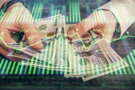 Multi exposure of technology drawing hologram and us dollars bills and man hands. Data conceptの写真素材