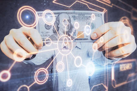 Multi exposure of social network theme drawing hologram and USA dollars bills and man hands.の写真素材