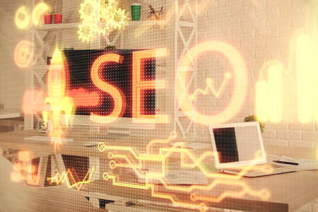 Double exposure of SEO drawing and office interior background. Concept of Search optimization engine.の写真素材