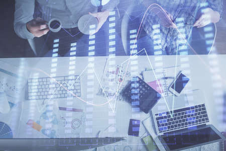 Double exposure of man and woman working together and financial chart hologram drawing. market...
