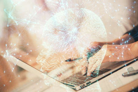 Double exposure of woman hands working on computer and brain hologram drawing. Ai concept.