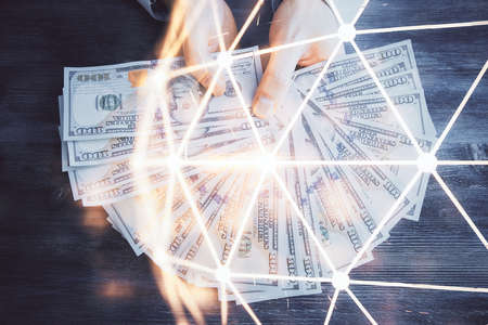 Multi exposure of social network theme drawing hologram and USA dollars bills and man hands.