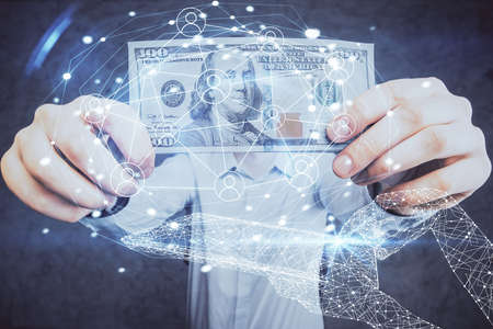 Multi exposure of social network theme drawing hologram and USA dollars bills and man hands.の写真素材