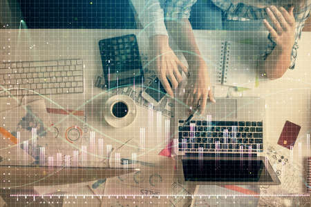 Double exposure of man and woman working together and financial graph hologram drawing. market...