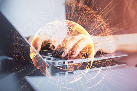 Double exposure of woman hands typing on computer and social network theme hologram drawing. People...