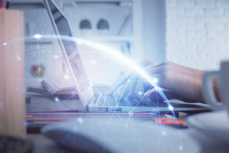 Double exposure of woman hands typing on computer and social network theme hologram drawing. People...