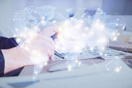 Double exposure of mans hands holding and using a phone and international business theme drawing.の写真素材