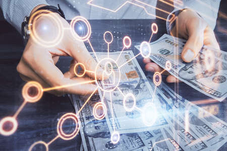 Multi exposure of social network theme drawing hologram and USA dollars bills and man hands.の写真素材