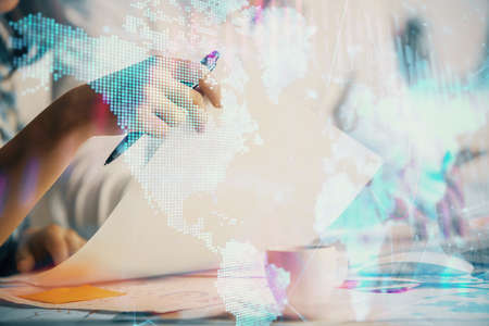 Double exposure of forex graph drawing over people taking notes background. Concept of financial analysisの写真素材