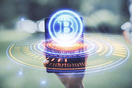Double exposure of blockchain business sketch hologram and woman holding and using a mobile device.の写真素材