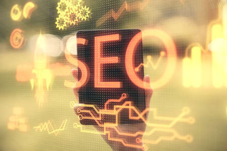 Double exposure of SEO sketch hologram and woman holding and using a mobile device.