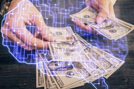 Multi exposure of brain drawing hologram and us dollars bills and man hands. Ai invest conceptの写真素材