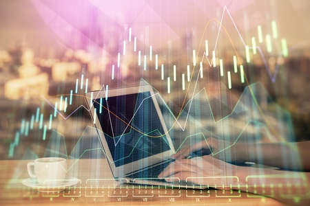 Double exposure of businesswoman hands typing on computer and forex chart hologram drawing....