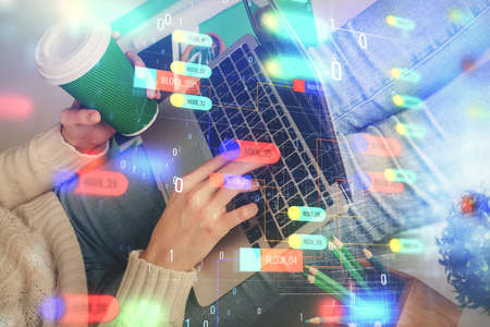 Double exposure of woman hands working on computer and data theme hologram drawing. Tech concept.
