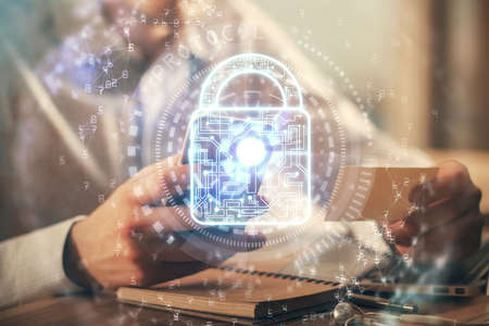 Multi exposure of mans hands holding and using a digital device and lock drawing. Security concept.