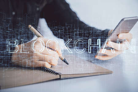 Double exposure of blockchain business sketch hologram and woman holding and using a mobile device.の写真素材