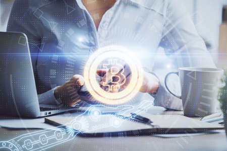 Double exposure of blockchain business sketch hologram and woman holding and using a mobile device.の写真素材