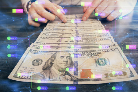 Double exposure of technology drawing hologram and us dollars bills and man hands. Data conceptの写真素材