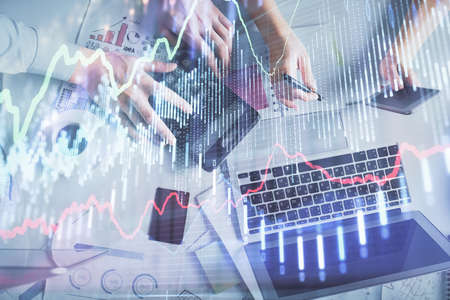 Double exposure of man and woman working together and financial chart hologram drawing. market...