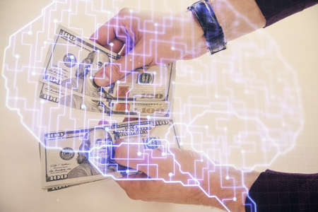 Multi exposure of brain drawing hologram and us dollars bills and man hands. Ai invest concept