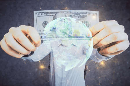 Multi exposure of social network theme drawing hologram and USA dollars bills and man hands.の写真素材