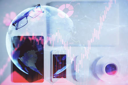 Double exposure of business theme hologram over desktop with phone. Top view. Mobile international...