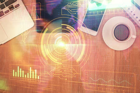 Double exposure of technology theme drawing over work table desktop. Top view. Global data analysis...