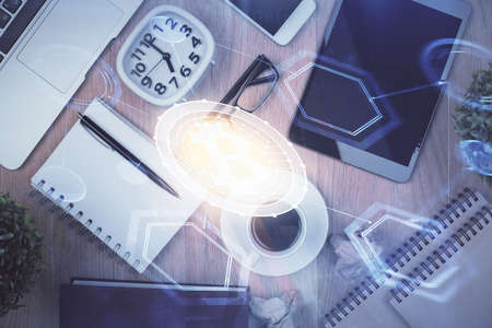 Double exposure of blockchain theme hologram over table with phone. Top view. Crypto technology concept.の写真素材
