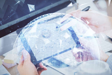 Double exposure of mans hands holding and using a phone and international business theme drawing.