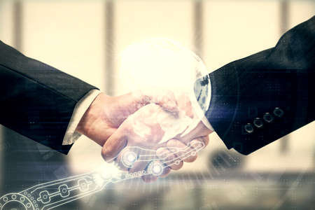 Double exposure of world map hologram and handshake of two men. International partnership concept.