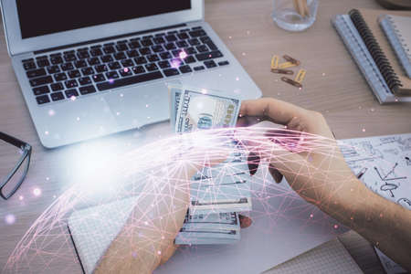 Multi exposure of social network theme drawing hologram and USA dollars bills and man hands.の写真素材