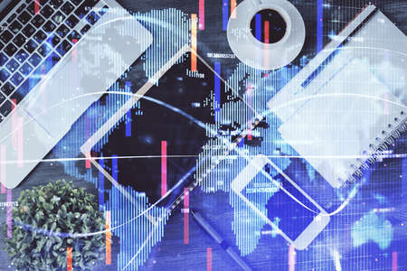 Double exposure of business theme hologram over desktop with phone. Top view. Mobile international trade connection concept.の写真素材